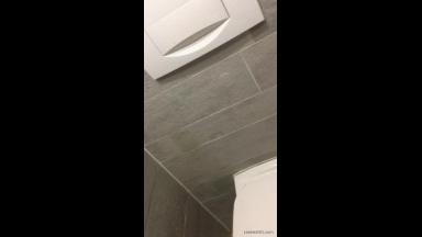 Milf giving a blowjob in a public bathroom