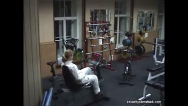 Charming doll exercising naked in the gym